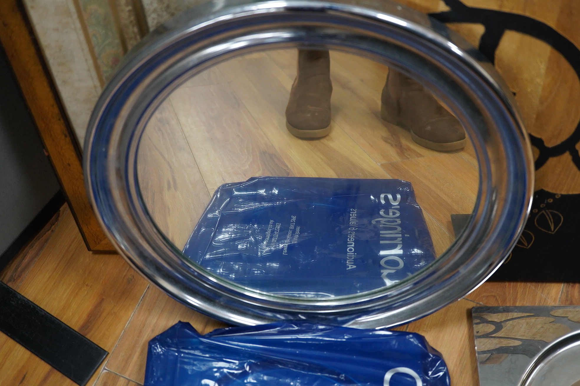 A framed botanical print, circular mirror, floral wood block and a set of metal place mats